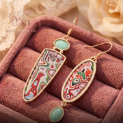 Gold leaf drop earrings worn